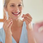 first, flossing or brushing